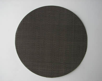 A round dutch weave black wire cloth filter disc.