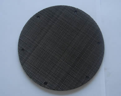 A round black wire cloth filter disc with spot welding.