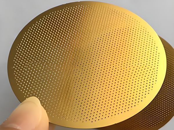 A brass perforated filter disc without covered wrapping.