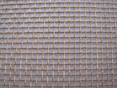 A piece of round wire copper wire mesh on the gray background.