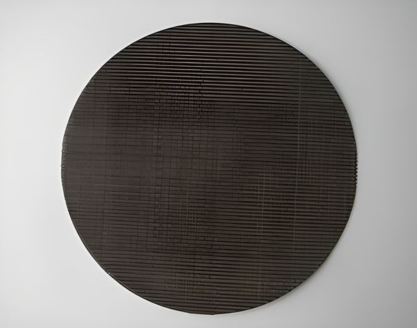 A round dutch weave black wire cloth filter disc.