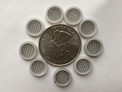 A metal coin is around by nine EPDM gasket edge small filters.