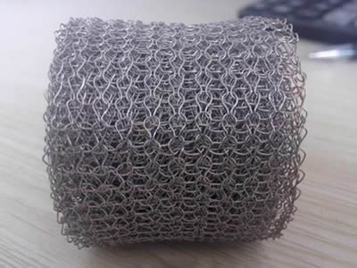 A roll of stainless steel knitted mesh on the table.
