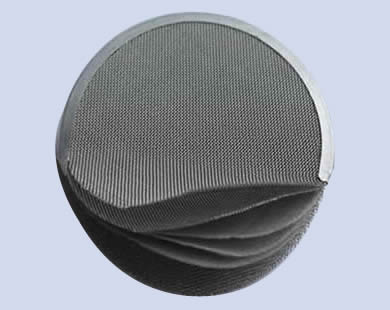A stainless steel filter disc with six layers.