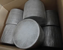 Several packs of filter discs packed with plastic film and then placed in carton.