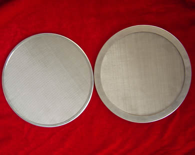 Two stainless steel wrapping edge filter discs.